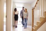 Realtor Showing Young Couple Around Property For Sale